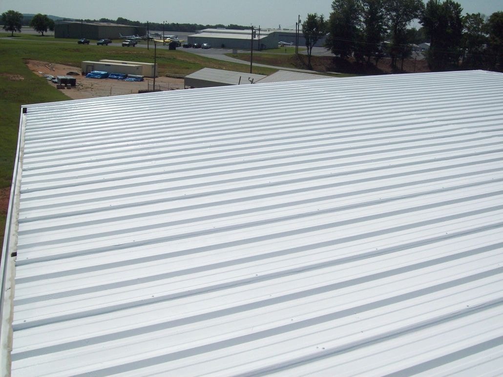 Completed roof coating — white metal roof aerial view